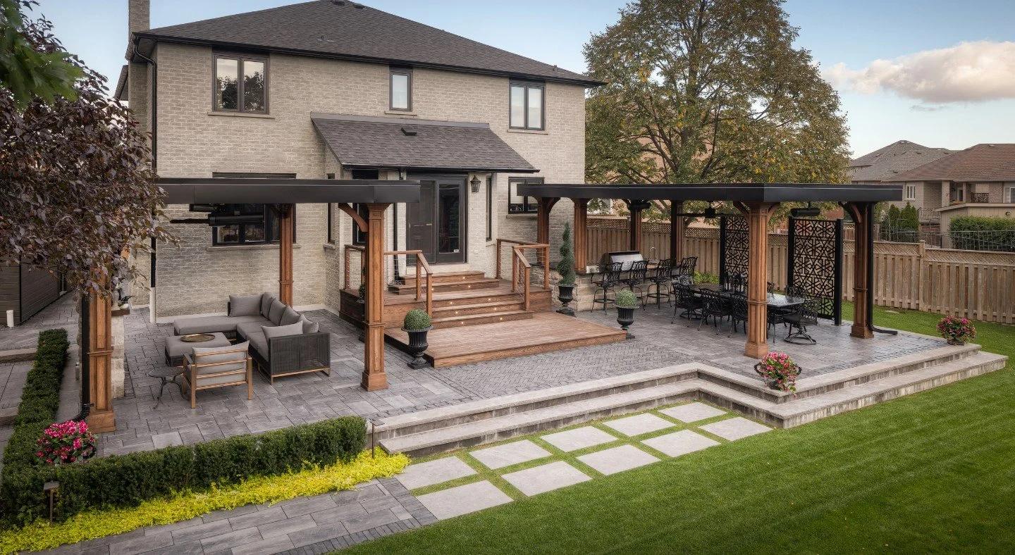 Landscaped backyard combining a timber deck and stone patio for outdoor entertaining