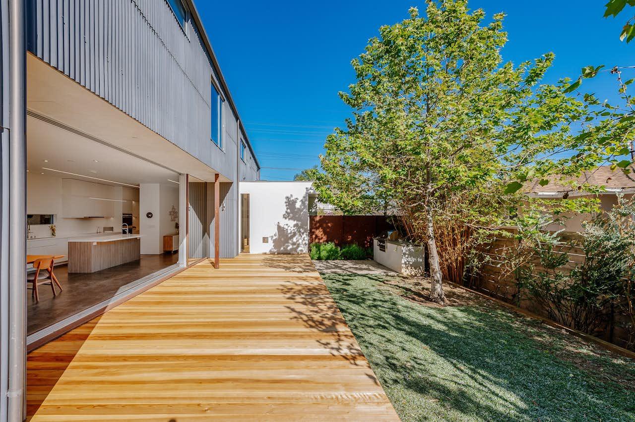 Modern wooden deck creating a spacious outdoor living area in a small backyard