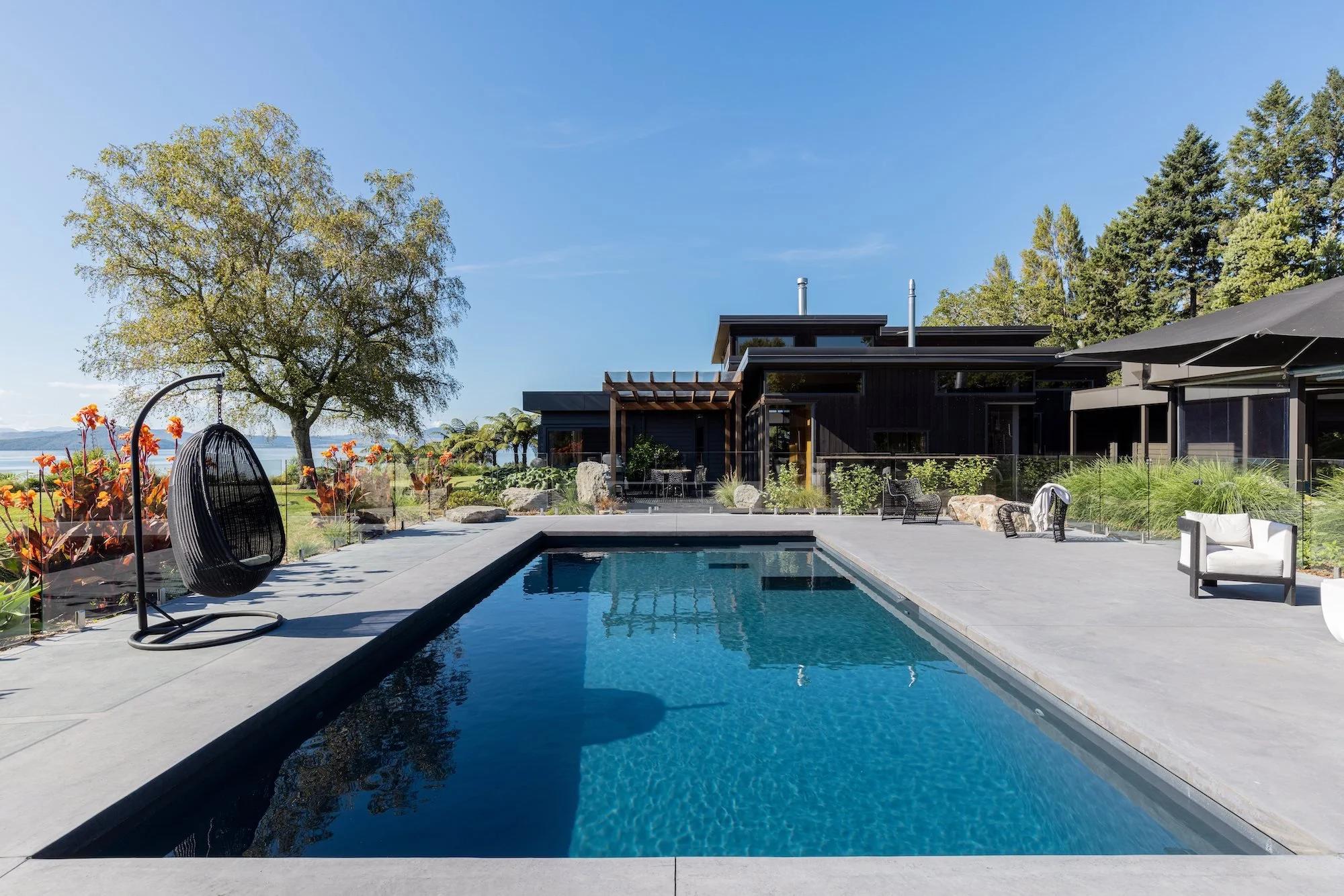 Fiberglass swimming pool designed to complement a landscaped Vancouver backyard
